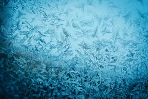 Frosty christmas pattern at a winter window glass Stock Photos