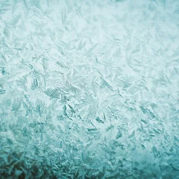 Frosty christmas pattern at a winter window glass Stock Photos