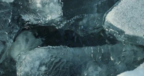 On a frosty day, the purest stream flows through transparent crystal clear ice. Stock Footage 201518787