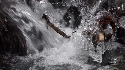 Frosty flowing mountain stream with ice and ice floes in December Stock Footage 166750043