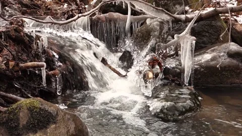 Frosty flowing mountain stream with ice and ice floes in December Stock Footage 166750295