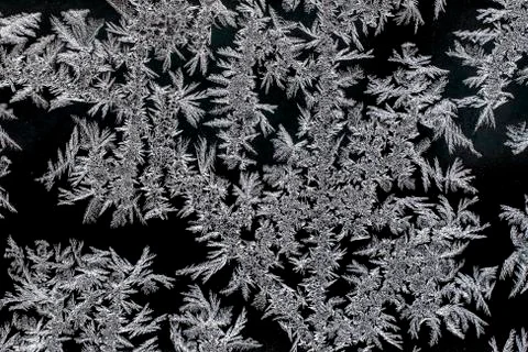 Frosty natural pattern on a winter window, texture of frosty patterns Stock Photos