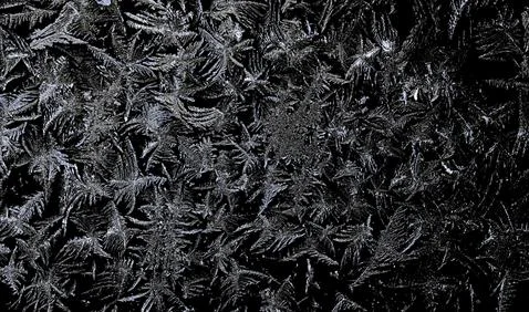 Frosty pattern on black background Stock Photos