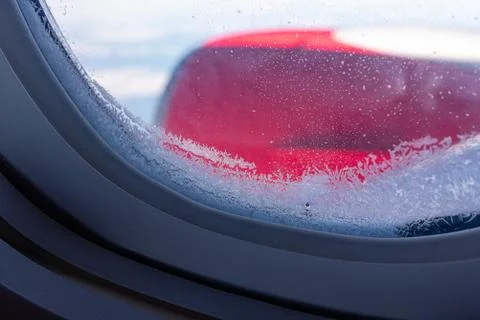 Frosty pattern on the glass window of the aircraft Stock Photos