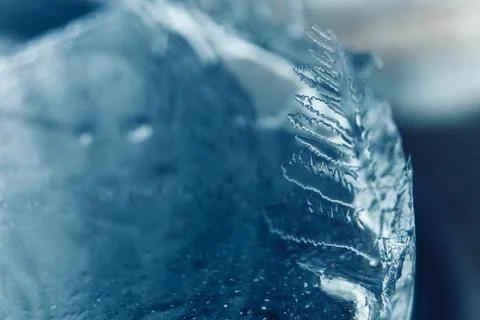 Frosty pattern in nature. Texture of ice and water. Stock Photos