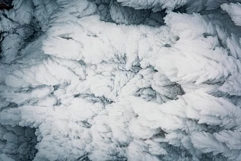 Frosty pattern on a wall of a mountain hut. Frozen snow covered land. Stock Photos