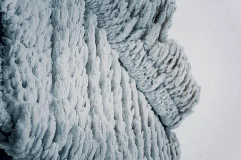 Frosty pattern on a wall of a mountain hut. Frozen snow covered land. Stock Photos