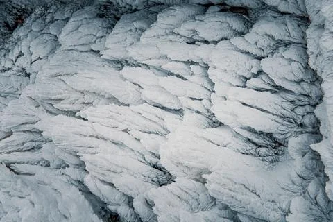 Frosty pattern on a wall of a mountain hut. Frozen snow covered land. Stock Photos