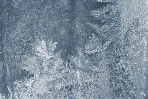 Frosty pattern on the window pane. Stock Photos