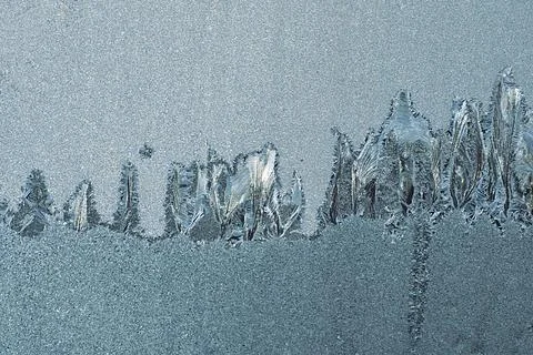Frosty pattern on the window pane. Stock Photos