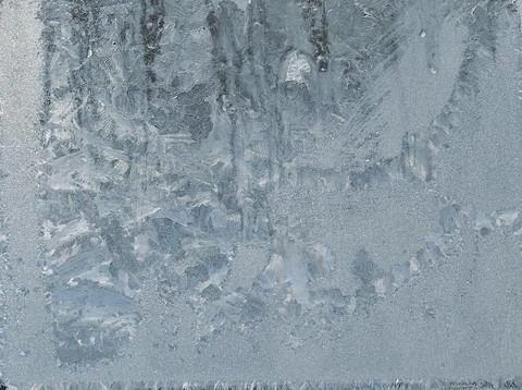 Frosty pattern on the window pane. Stock Photos