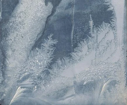 Frosty pattern on the window pane. Stock Photos