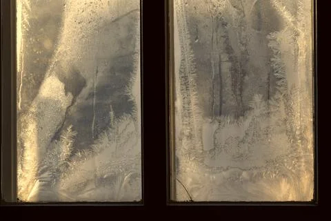 Frosty pattern on the window pane. Stock Photos
