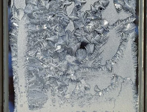 Frosty pattern on the window pane. Stock Photos