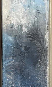 Frosty pattern on the window pane. Stock Photos
