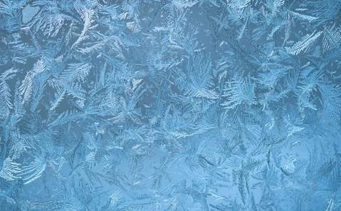 Frosty pattern on the window pane. Winter background Stock Photos