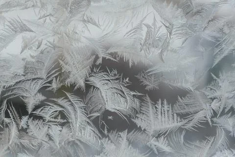 Frosty pattern on window in winter season Stock Photos