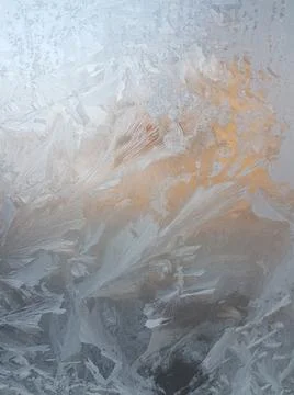 Frosty pattern on the window on a winter sunrise Stock Photos