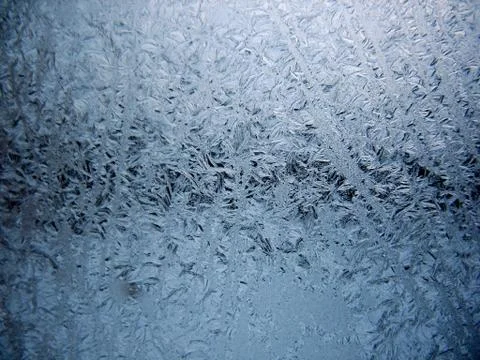 Frosty pattern on winter window Stock Photos