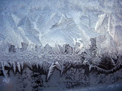Frosty pattern on winter window Stock Photos
