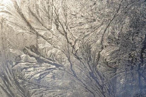 Frosty patterns on the glass window Stock Photos