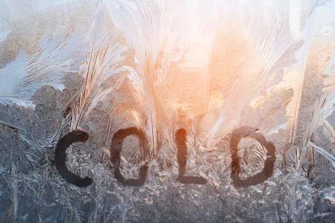 Frosty patterns on glass, winter background. Inscription on the window Stock Photos