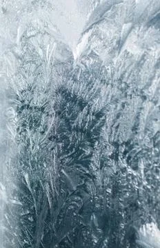 Frosty patterns on glass in winter Stock Photos