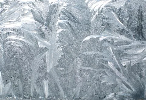 Frosty patterns on glass in winter Stock Photos