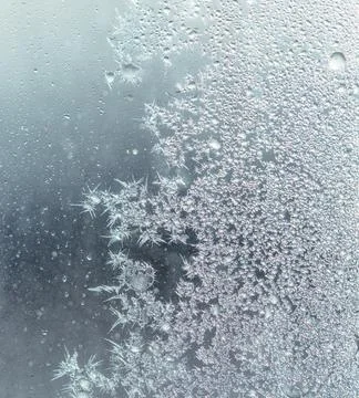 Frosty patterns on the window glass as a background 写真素材