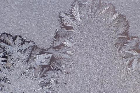 Frosty patterns on the window glass closeup Stock Photos