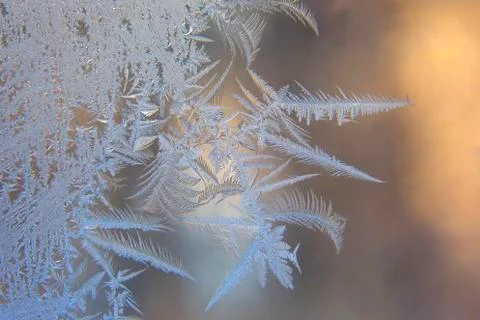 Frosty patterns on the window glass closeup. natural textures and backgrounds Stock Photos