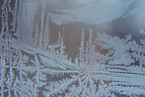 Frosty patterns on the window glass closeup. natural textures and backgrounds Stock Photos