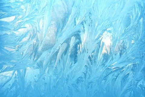 Frosty patterns on the window glass closeup. natural textures and backgrounds Stock Photos
