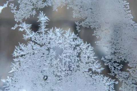 Frosty patterns on the window glass closeup. natural textures and backgrounds Stock Photos