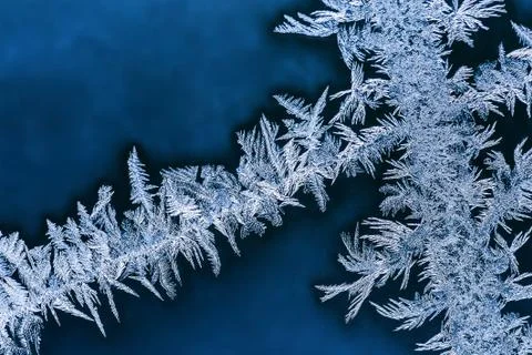 Frosty patterns on winter window glass macro Stock Photos