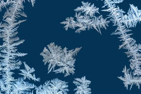 Frosty patterns on winter window glass macro Stock Photos
