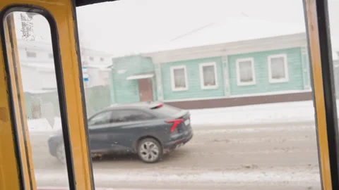 Frosty village scenes develop. Snowy road seen through home entrance. Everyday Stock Footage 335320603