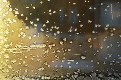Frosty Window Pane with Snowflake Patterns at Golden Hour Stock Photos