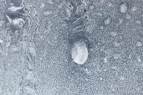 A frosty window with a small white circle in the middle Stock Photos