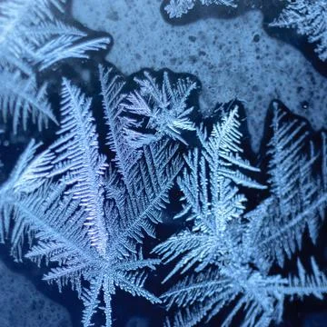 Frosty winter pattern at a window glass, macro texture Stock Photos