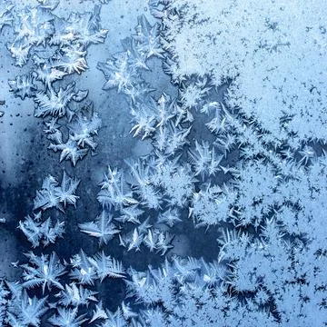 Frosty winter pattern at a window glass, macro texture Stock Photos
