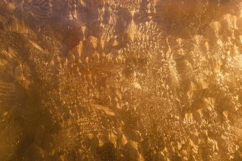 Frosty Winter Patterns on Icy Golden Glass Stock Illustration