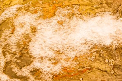 Froth, Air Bubble Circulation in glowing golden colored light reflection on s Stock Photos