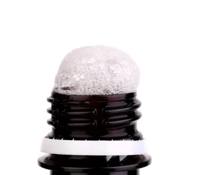 Froth cap of open beer bottle Fotos Stock