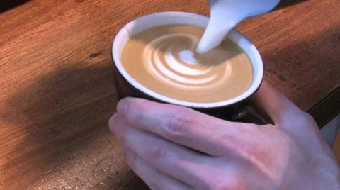 Froth from milk makes a pattern in the cappuccino Stock Footage