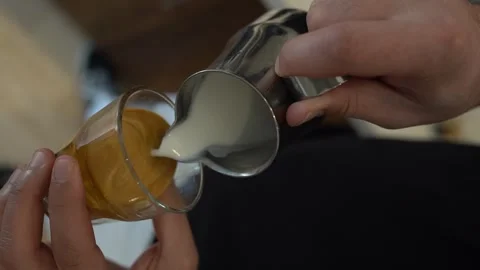 Frothed Milk Is Poured Into Espresso, Making Coffee, Latte Art Video Stock Footage 252628843