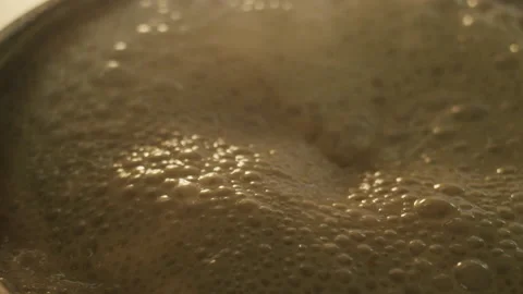 The frothing and boiling sauce is cooked in a hot saucepan Video stock 154148283
