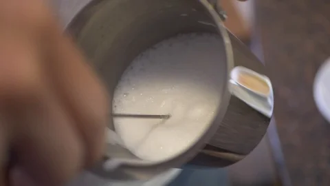 Frothing milk with electric whisk Stock Footage 126946953
