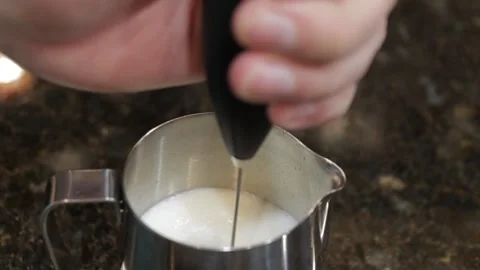 Frothing Milk In A Steele Cup Stock Footage 139012610