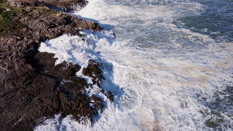 Frothing waves crash into rugged rocky coastline of Hermanus at Sievers Stock Footage 245278461